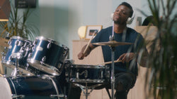 man playing drums after tuning drums 